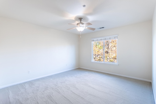 carpeted spare room with ceiling fan