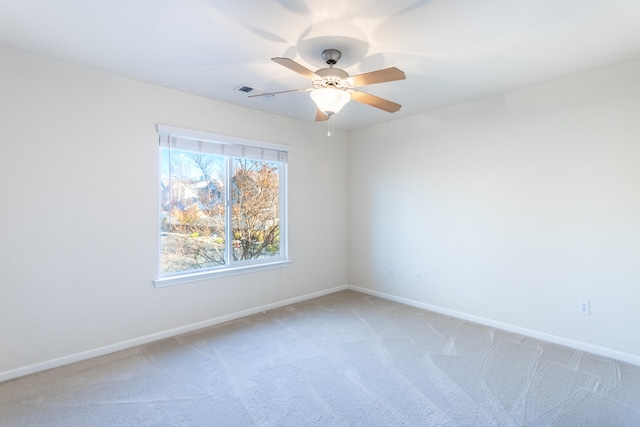 spare room featuring carpet and ceiling fan