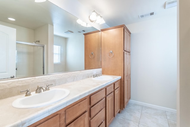 bathroom featuring tile patterned flooring, vanity, and an enclosed shower