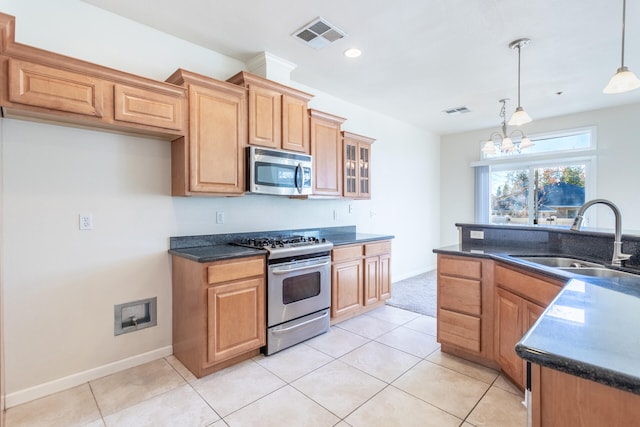 kitchen with sink, decorative light fixtures, light tile patterned flooring, stainless steel appliances, and a chandelier