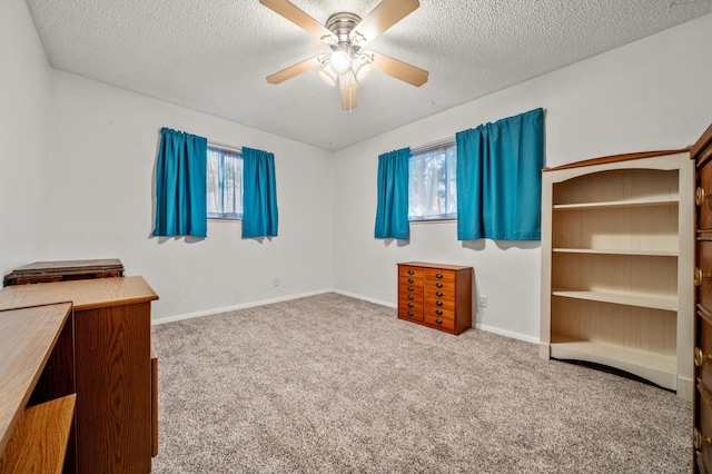 unfurnished bedroom with a textured ceiling, carpet floors, and multiple windows