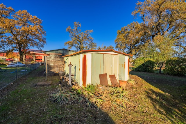 view of outbuilding featuring a lawn