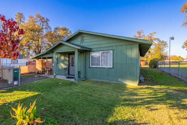 rear view of house with a yard