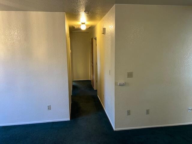 unfurnished room featuring a textured ceiling