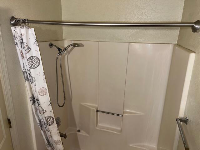 bathroom with shower / bathtub combination with curtain