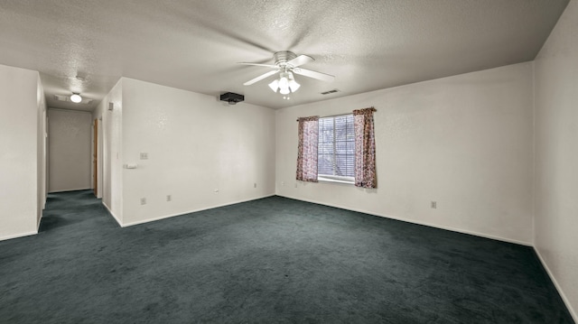 unfurnished room featuring ceiling fan, a textured ceiling, dark colored carpet, baseboards, and visible vents
