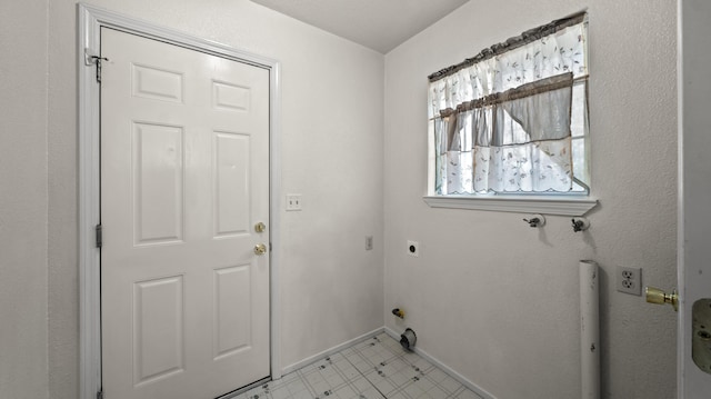 laundry area with baseboards, hookup for an electric dryer, laundry area, and light floors