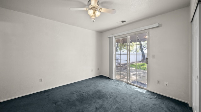 empty room with baseboards, a ceiling fan, dark carpet, and visible vents