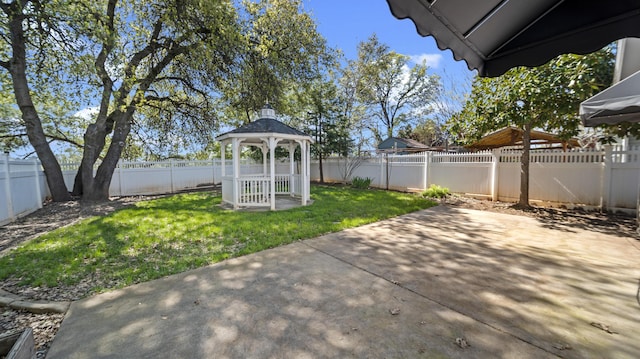 view of yard with a gazebo, a fenced backyard, and a patio area