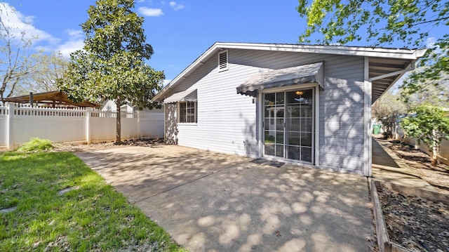 back of property featuring a patio and fence