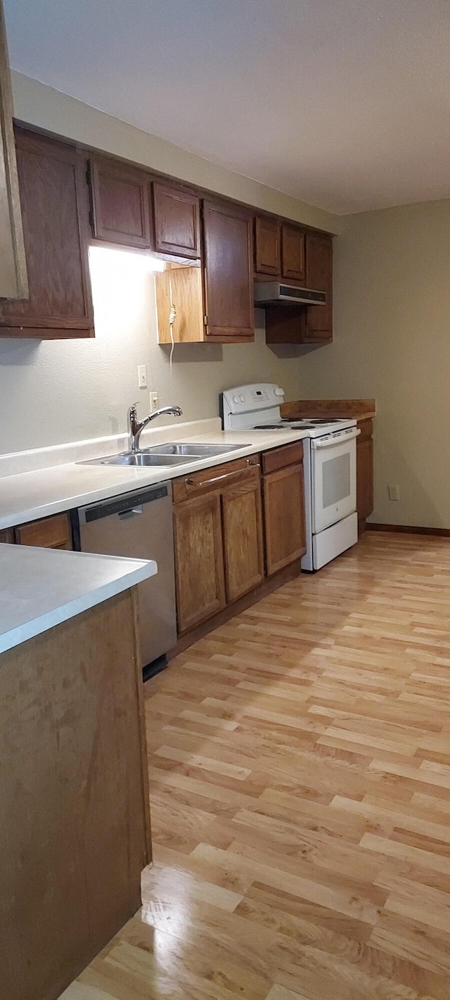 kitchen with sink, dishwasher, light hardwood / wood-style floors, and white electric range