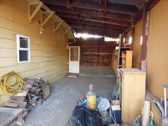 misc room with concrete floors and vaulted ceiling