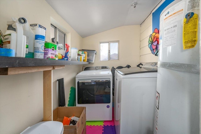 laundry area featuring water heater and washing machine and clothes dryer