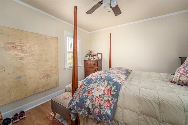 bedroom featuring hardwood / wood-style floors, ceiling fan, and ornamental molding