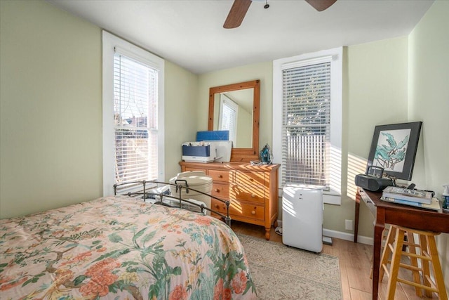 bedroom with ceiling fan and light hardwood / wood-style flooring