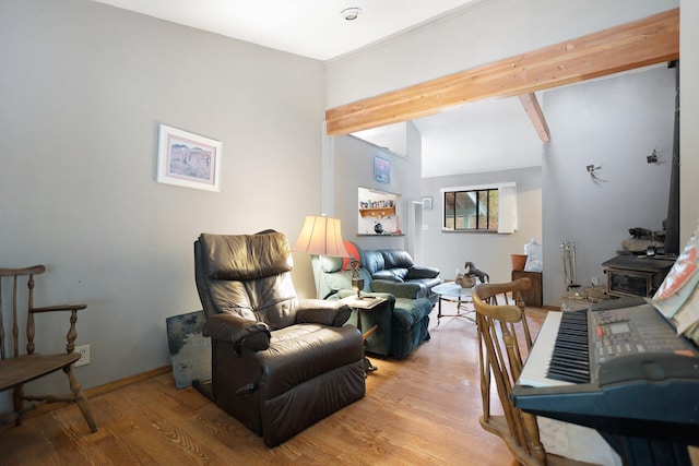 living room featuring beam ceiling and light hardwood / wood-style flooring