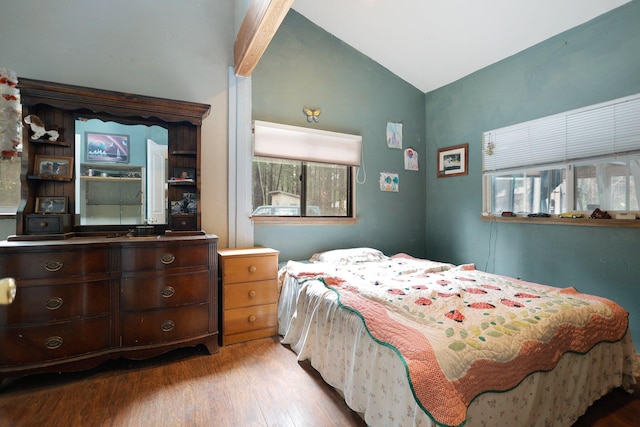 bedroom with light wood-type flooring and vaulted ceiling