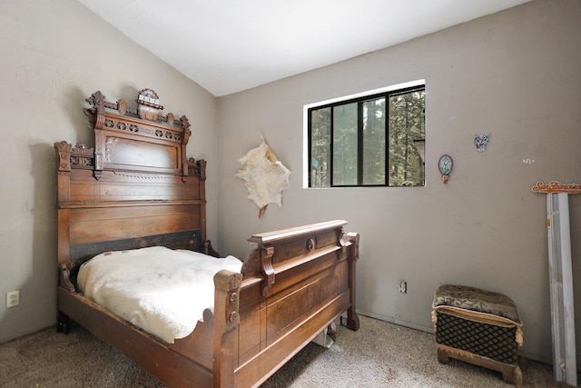 carpeted bedroom featuring vaulted ceiling