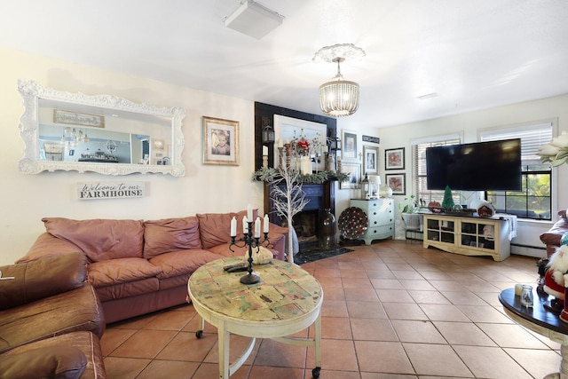 tiled living room with a chandelier and a baseboard heating unit