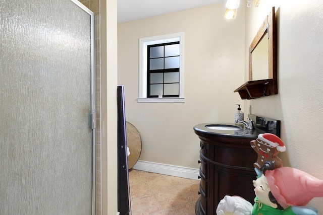 bathroom with tile patterned flooring, vanity, and a shower with shower door