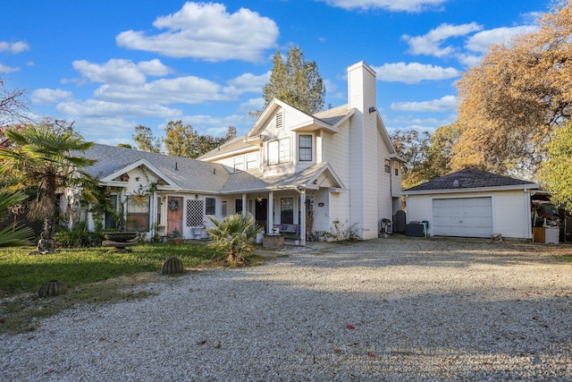 front of property with a garage and an outdoor structure