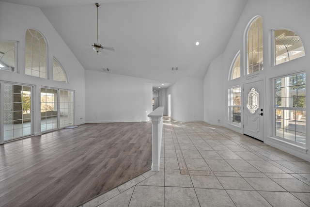 entrance foyer featuring ceiling fan, light hardwood / wood-style floors, and high vaulted ceiling