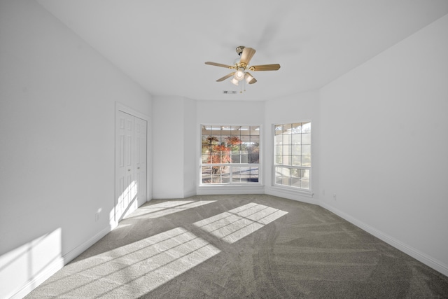 carpeted empty room featuring ceiling fan