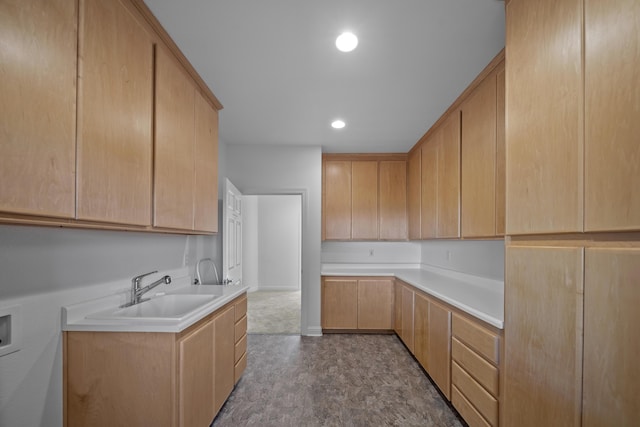 kitchen featuring light brown cabinetry and sink