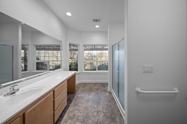 bathroom with hardwood / wood-style floors, plenty of natural light, an enclosed shower, and vanity