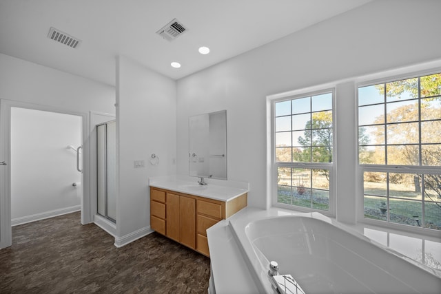 bathroom with shower with separate bathtub, vanity, and hardwood / wood-style flooring