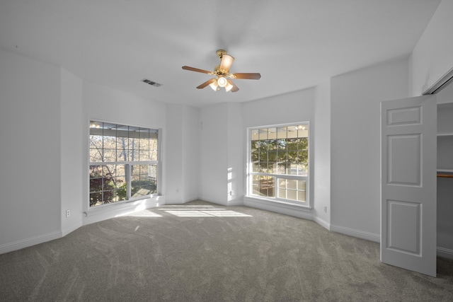 carpeted empty room featuring ceiling fan