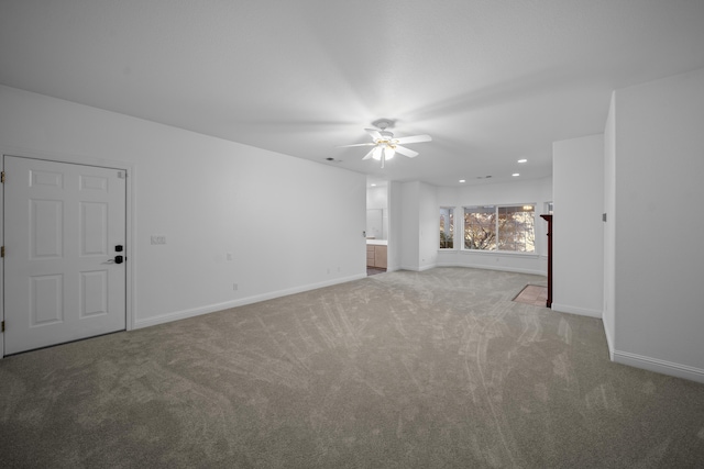 unfurnished living room featuring ceiling fan and carpet