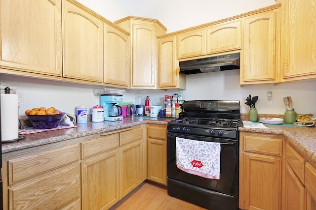 kitchen with black gas range, light hardwood / wood-style floors, and light brown cabinetry