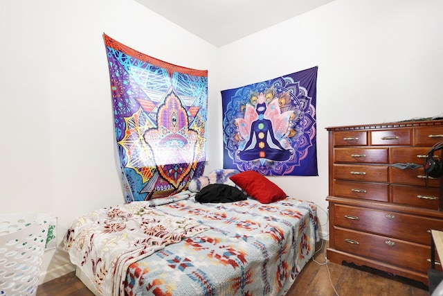 bedroom with dark wood-type flooring