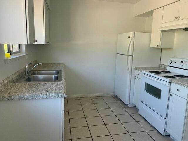 kitchen with white cabinets, sink, light tile patterned floors, and white electric stove