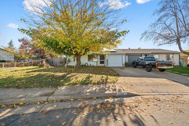 view of front of property with a garage and a front lawn