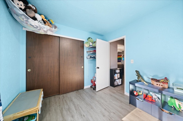 game room with light wood-type flooring