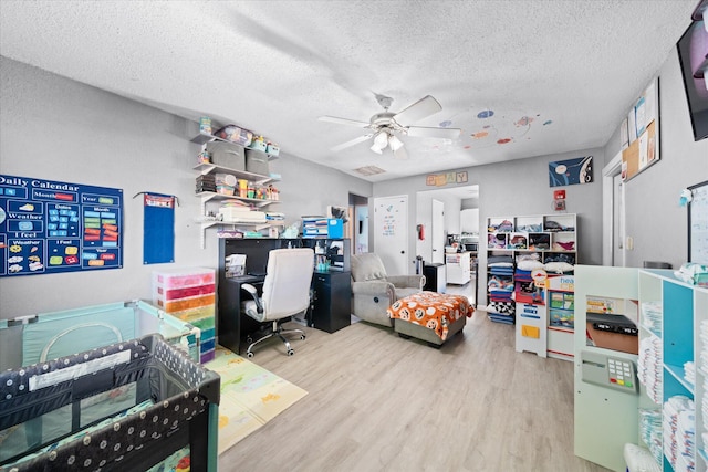 office area featuring wood-type flooring, a textured ceiling, and ceiling fan