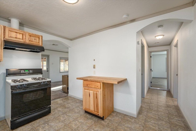 kitchen featuring a textured ceiling, light brown cabinets, butcher block counters, and black gas range oven