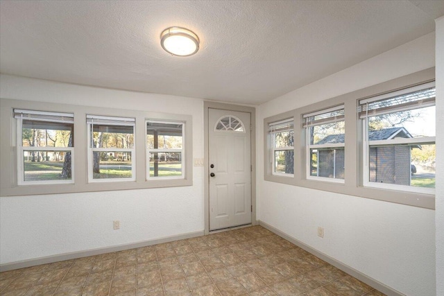 foyer entrance featuring a textured ceiling