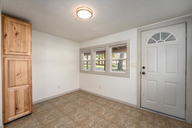 foyer featuring a textured ceiling