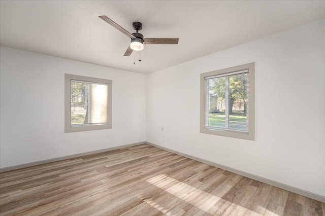 unfurnished room featuring ceiling fan and light wood-type flooring