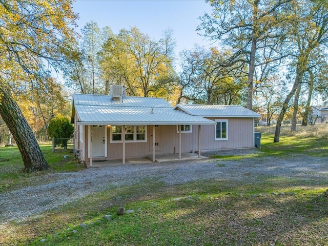 rear view of property featuring a yard