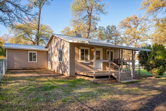 rear view of property with a lawn and a wooden deck