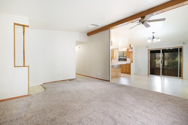 unfurnished living room featuring ceiling fan with notable chandelier and lofted ceiling