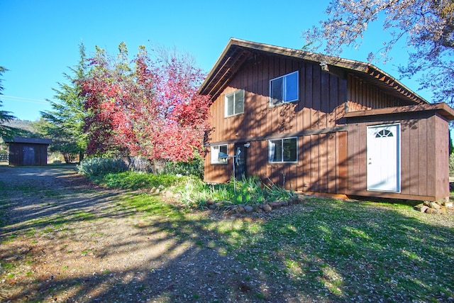 view of side of property with a lawn