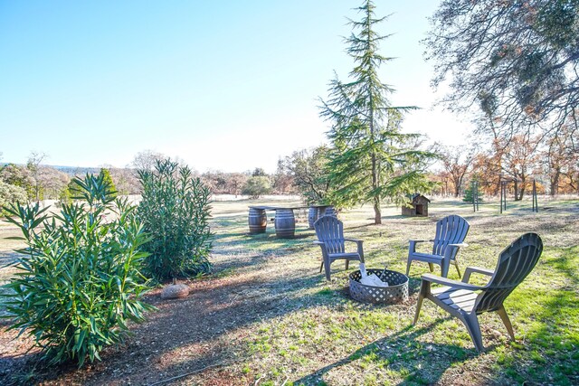 view of yard with an outdoor fire pit