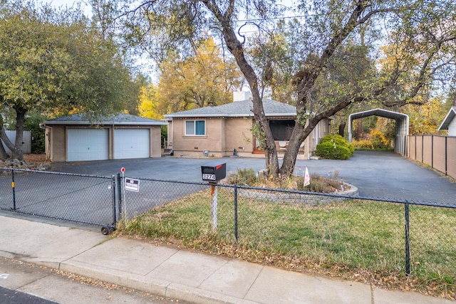 single story home featuring an outbuilding and a garage