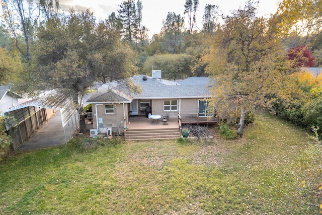 rear view of property featuring a wooden deck and a yard