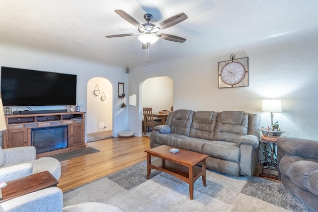 living room featuring ceiling fan and light hardwood / wood-style floors